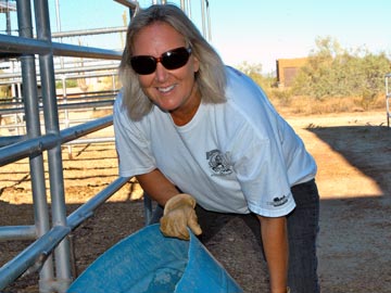 smiling volunteer emptying water tub