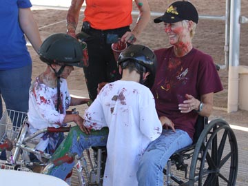 paint-splattered volunteer and 2 students