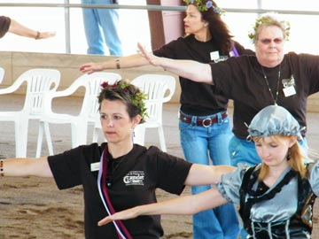 volunteers walking with arms outspread at Hooves and Heroes performance
