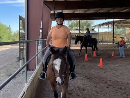Heidi riding Nutmeg in the covered arena