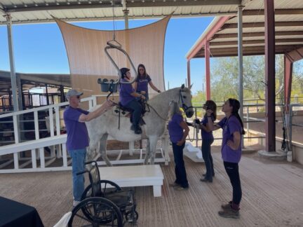 Student mounted with the SureHands lift